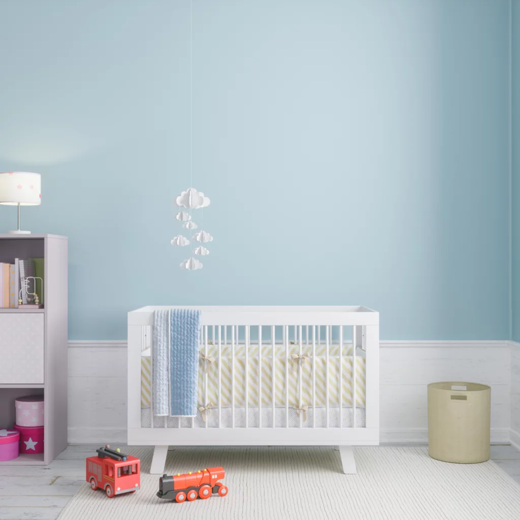 Baby's room with crib, toys, and soft furniture for decorating on a budget