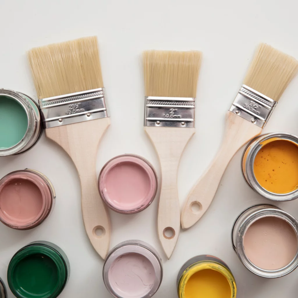 Paint cans and brushes for decorating on a budget