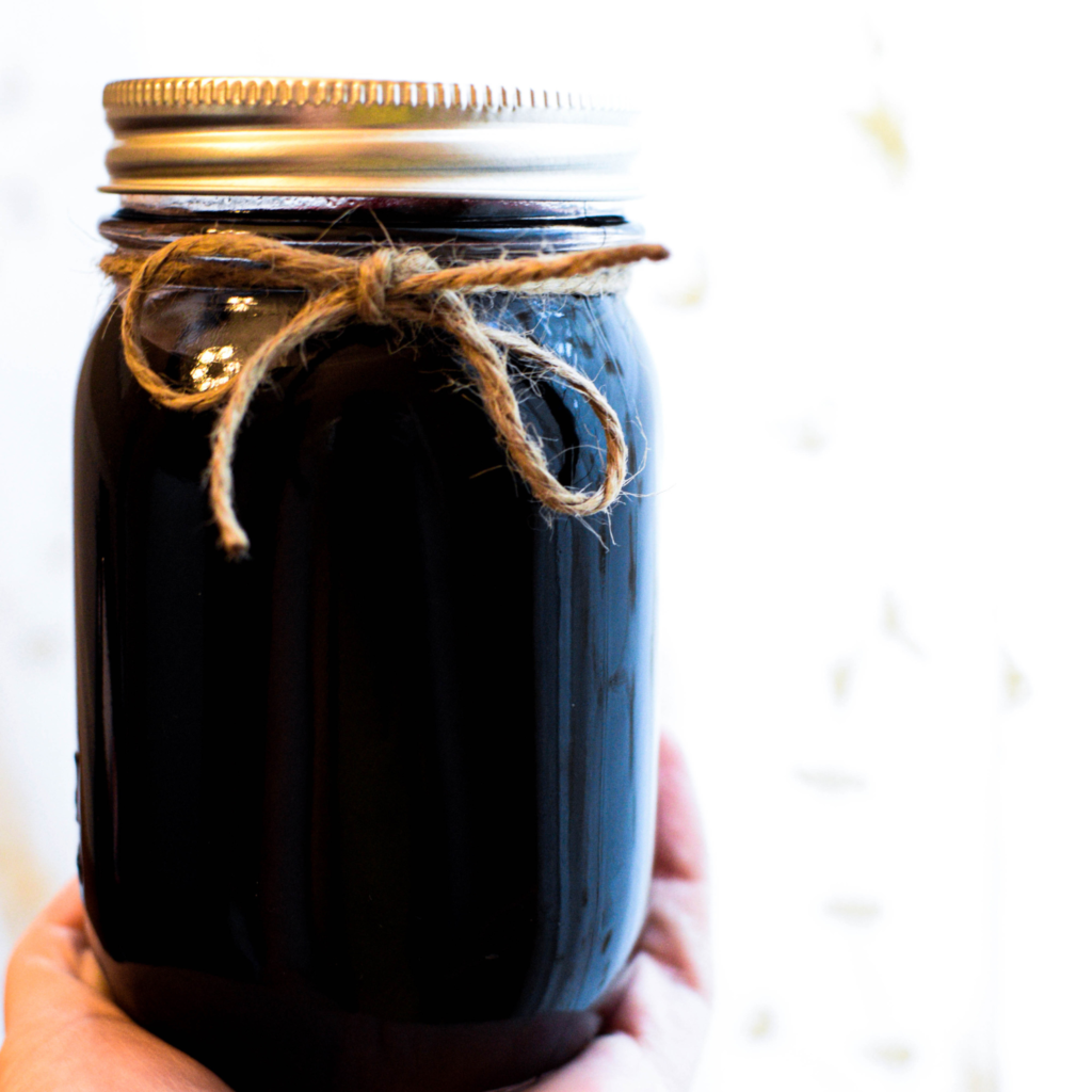 mason jar filled with homemade elderberry syrup recipe