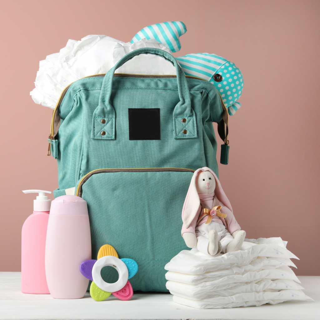Diaper bag with diapers, lotion, toys, and more for how to save money on baby