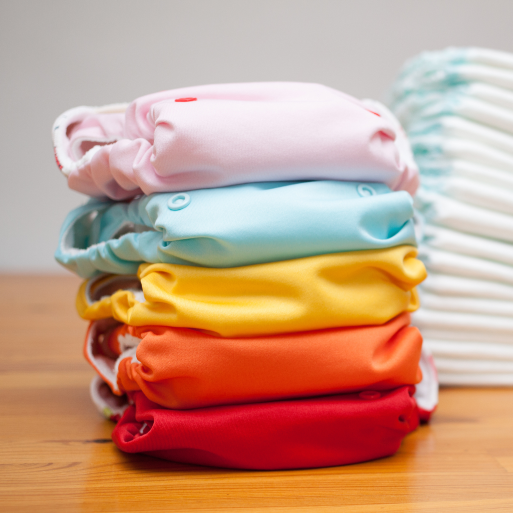 Stack of colorful cloth diapers for how to save money on baby