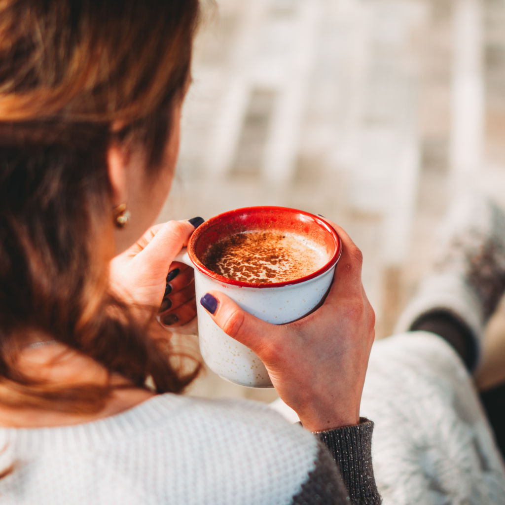 Woman drinking a cup of coffee for new year money challenge 