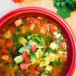 red bowl filled with healthy lime chicken & avocado soup