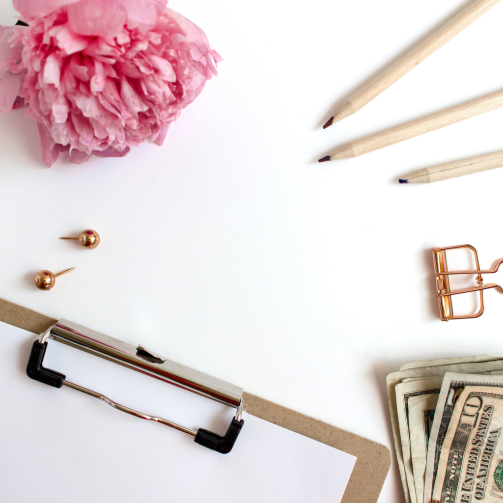 Money, paperclip, flower, and clipboard for 14 ways to kickstart financial spring cleaning