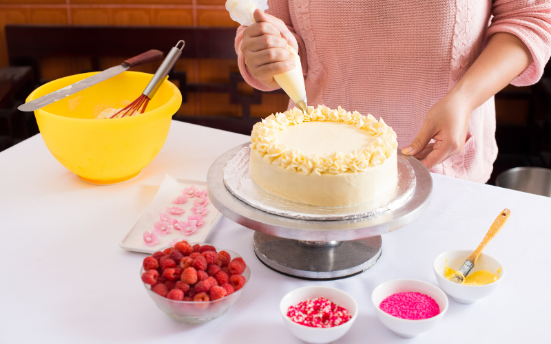 woman decorating cake for cooking hobbies for moms