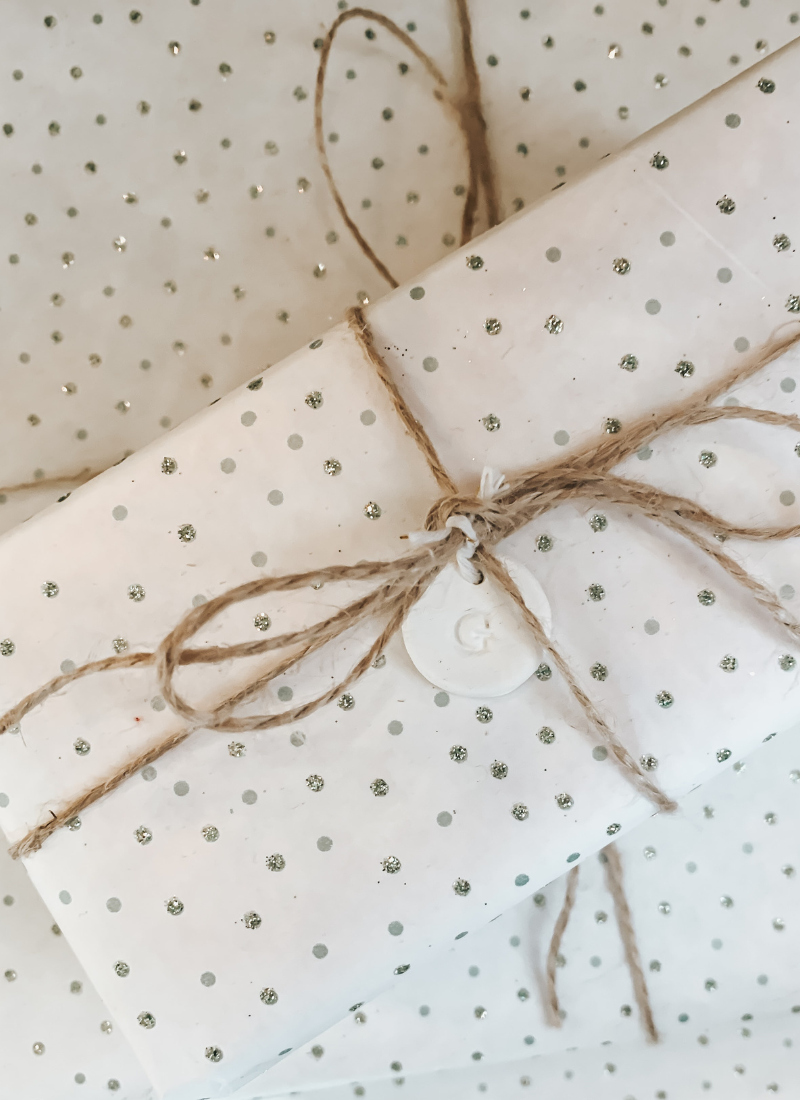 white and silver wrapping paper with twine as gifts for single moms