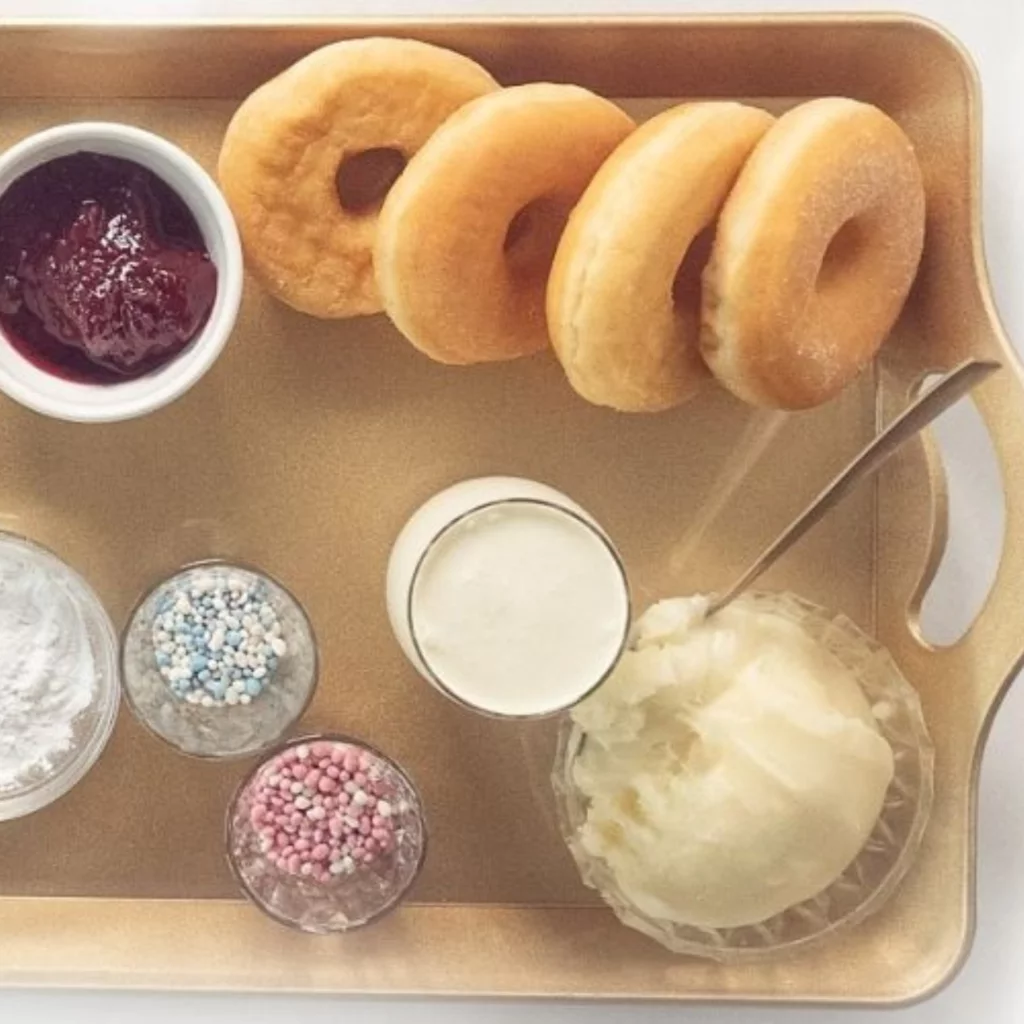 filled doughnuts with glaze on serving tray