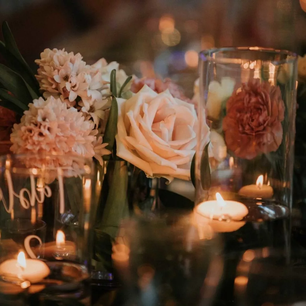 Budget friendly wedding centre pieces with flowers and candles.