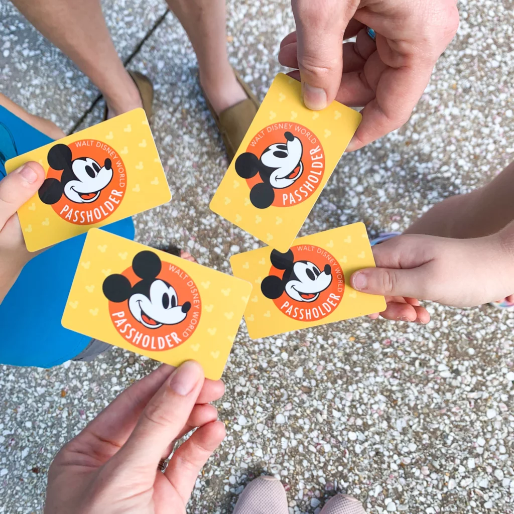 Disney Annual Passholder cards being held in family's hands. 