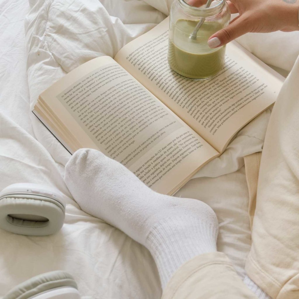 A fun thing to do in the winter inside is reading in your cozy bed. 