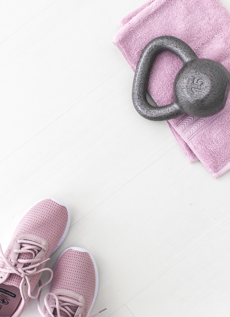 Kettlebell and athletic shoes shown for 10 Essentials For Your Minimalist Home Gym.