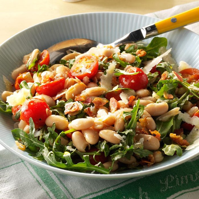 A salad made with white beans, arugula, tomatoes, and a handmade dressing. 