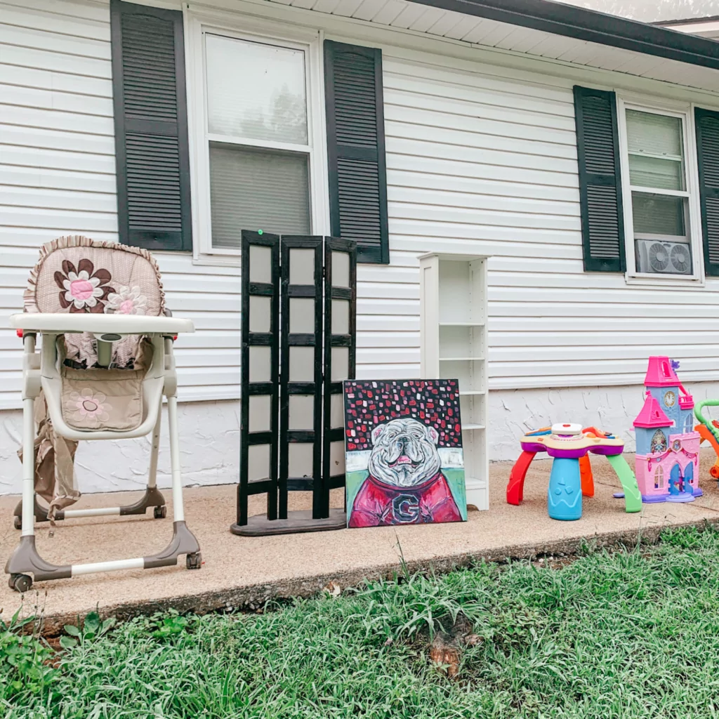 High chair, home decor, and toys are items you can set on the ground during a yard sale to save table space.