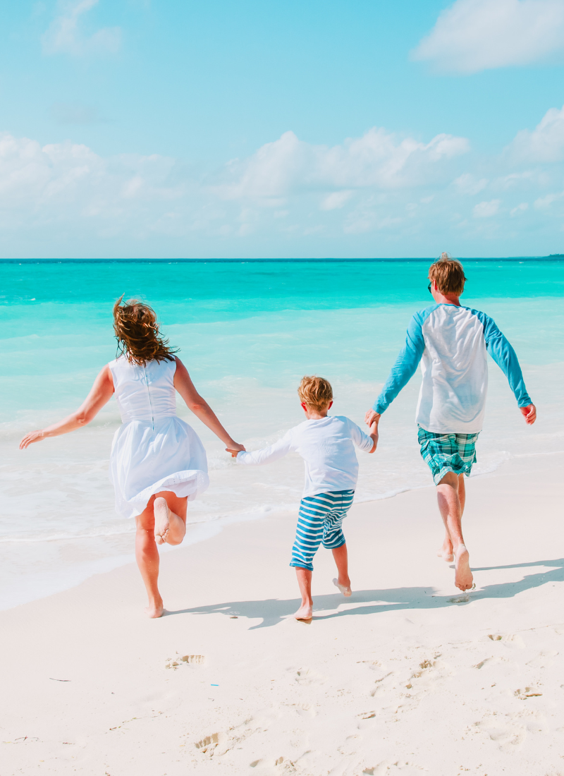 Kids running on a beach for family vacations in florida on a budget