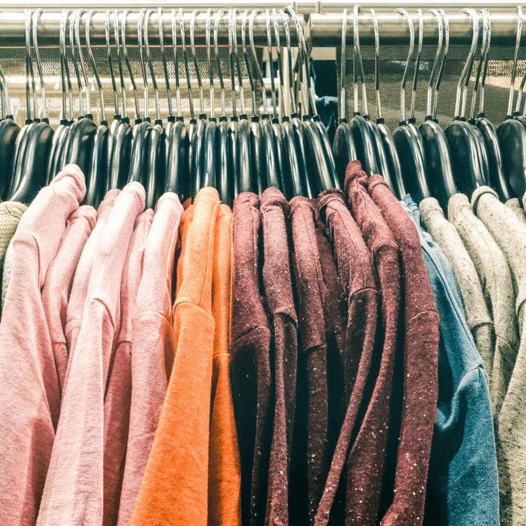 Clothes hanging on a rack for benefits of thrifting