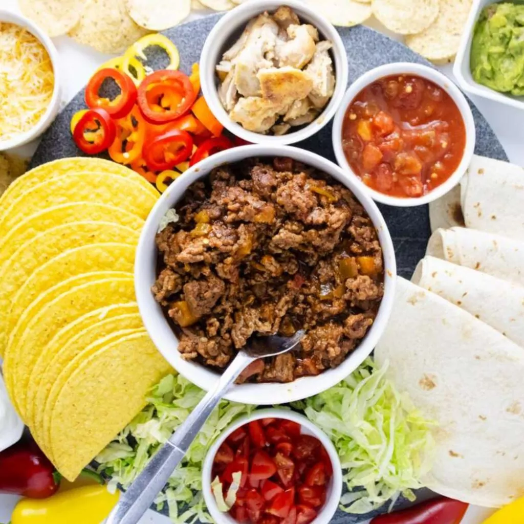 Tray with taco meat, tortillas, and all the trimmings for  wedding rehearsal dinner ideas on a budget