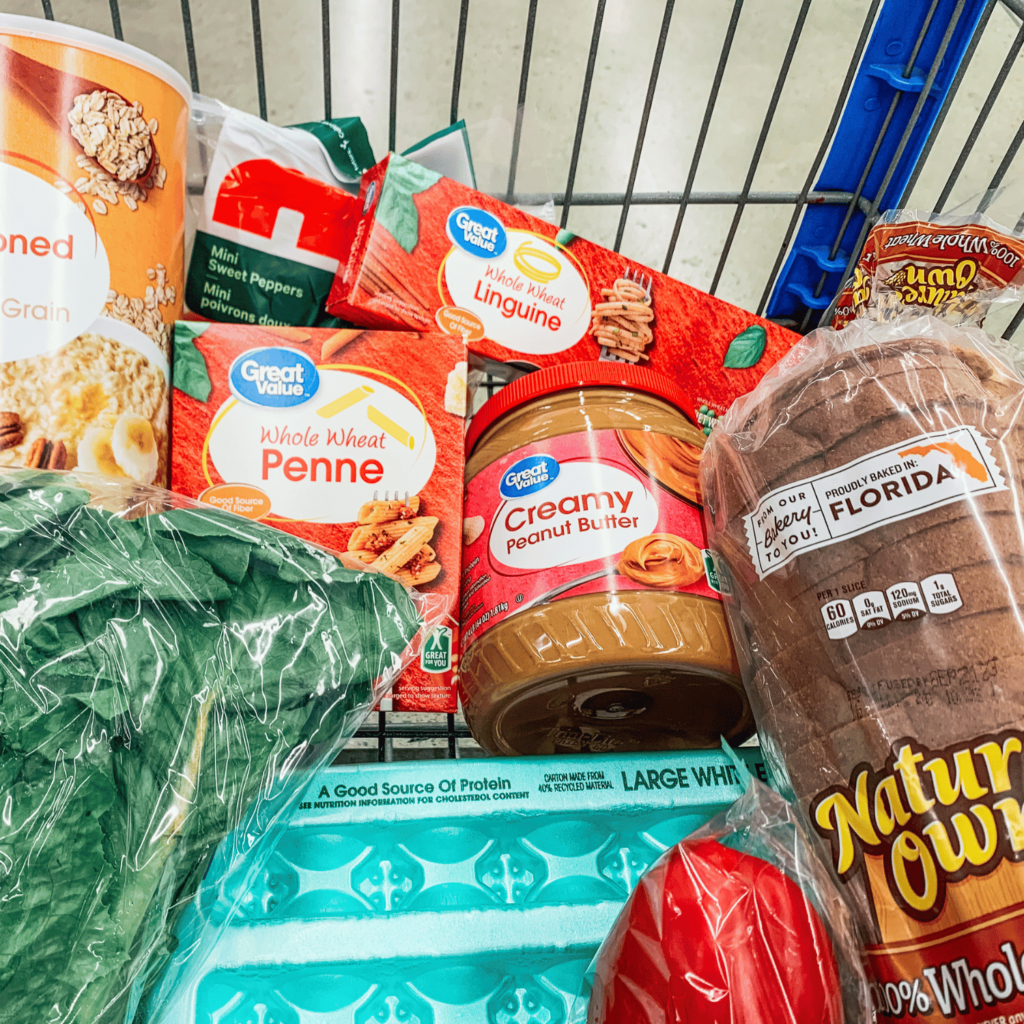 Shopping cart filled with groceries for cheap & healthy grocery list for a college student.