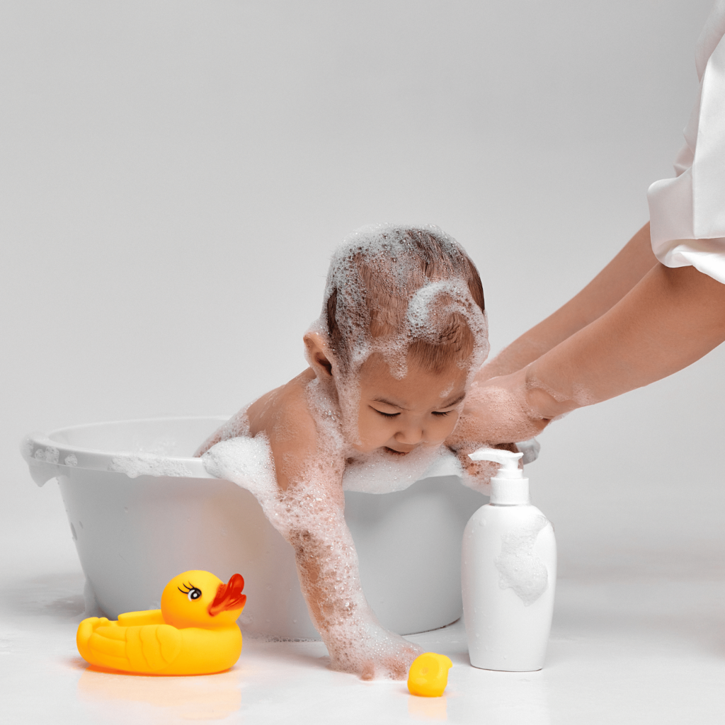 Baby in bathtub with rubber duck