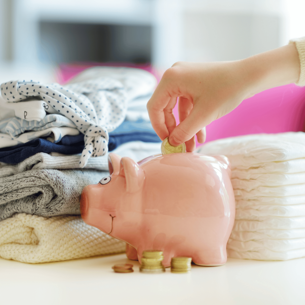 Piggy bank surrounded by diapers and baby supplies