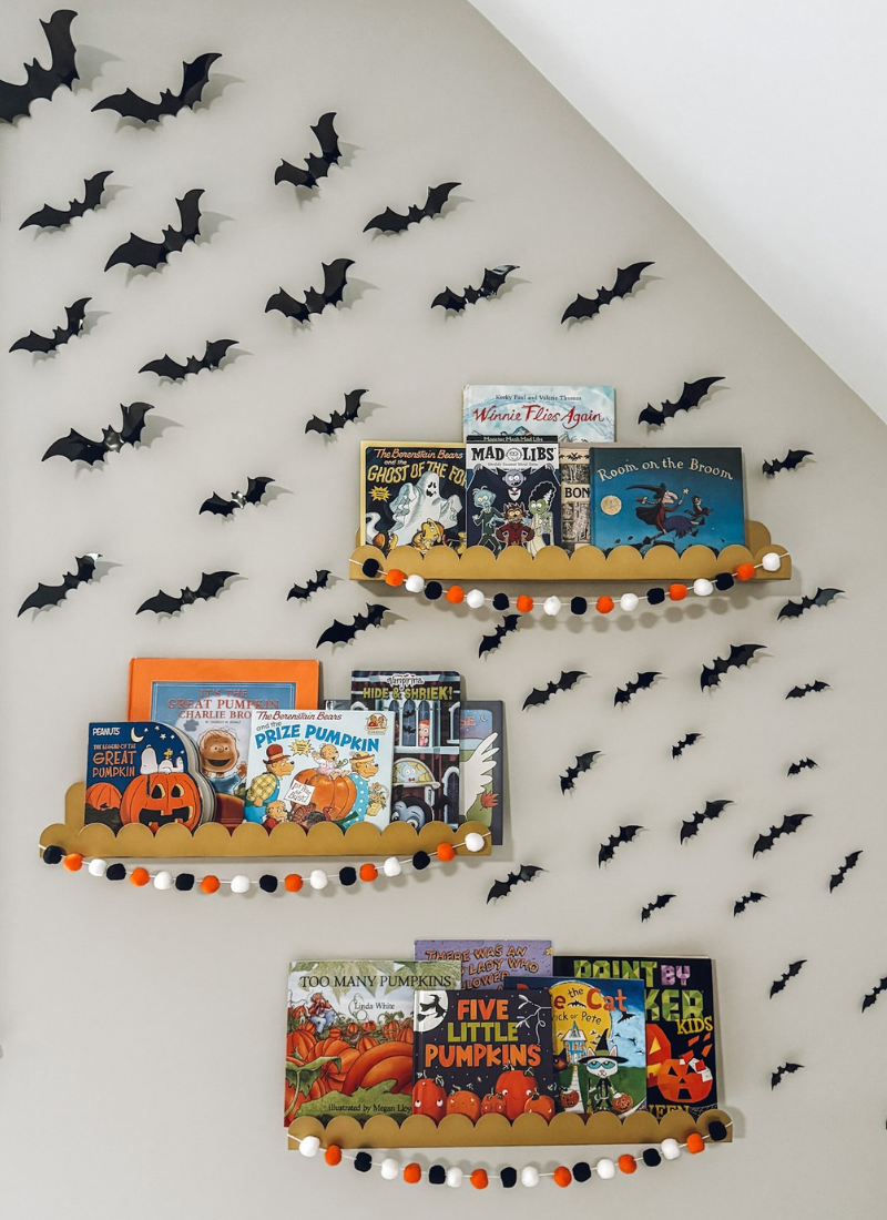 Well with paper bats and Halloween book on shelves for cheap Halloween decorations that look expensive